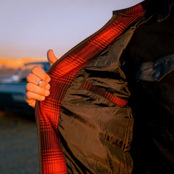 Close-up of flannel texture and technical details on the Holyfreedom custom riding jacket.
