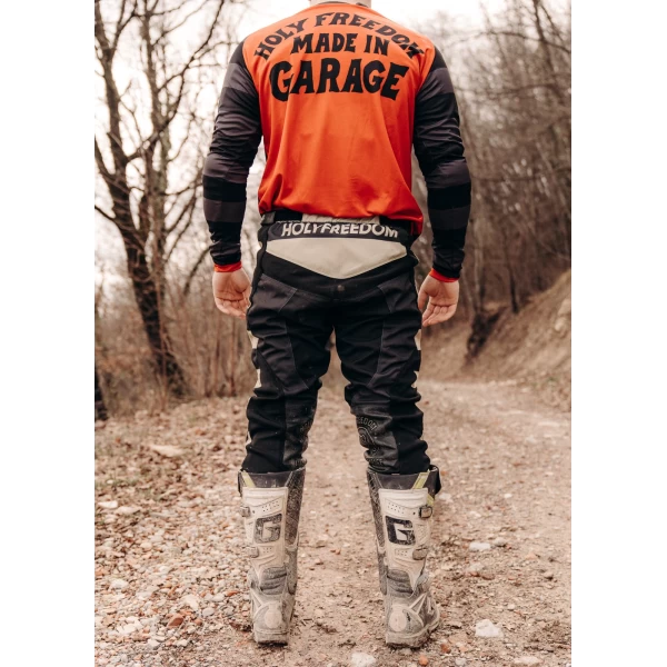 Mud Black trousers styled for off-road riding with custom jacket and boots.