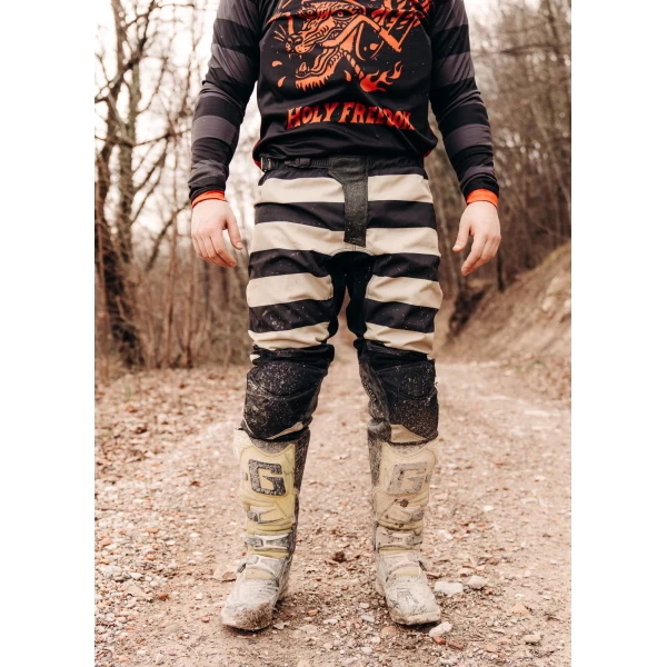 Mud Black trousers styled for off-road riding with custom jacket and boots.