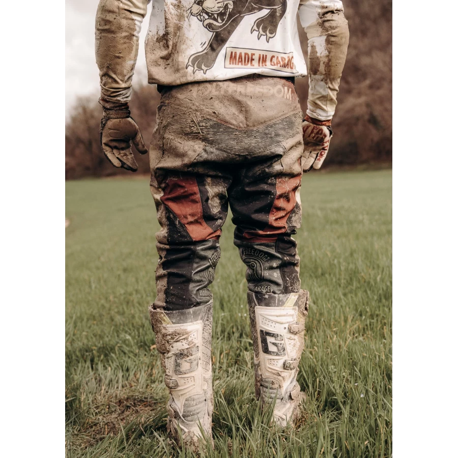 Mud Bordeaux trousers styled off-road with custom jacket and moto boots.