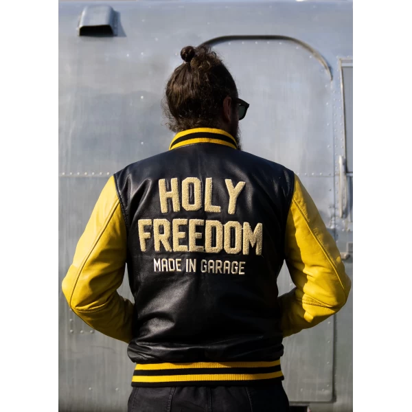 Yellow varsity jacket fitted on a rider for streetwear and motorcycle use