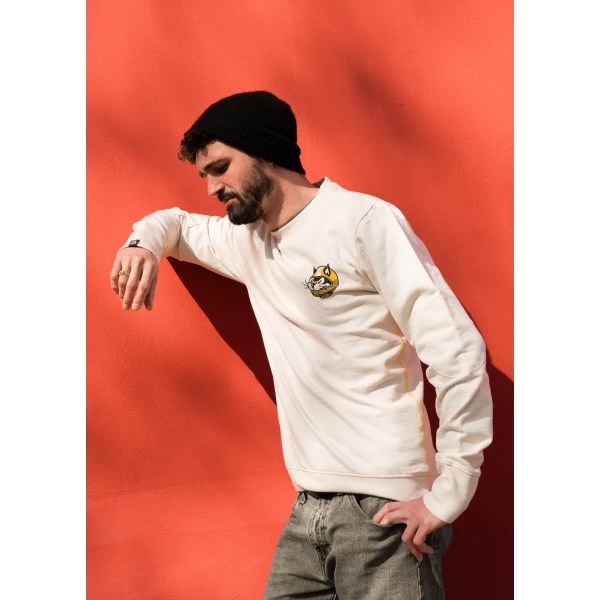 Close-up of the AstroCatz original graphic on a custom sweatshirt with artist detail.