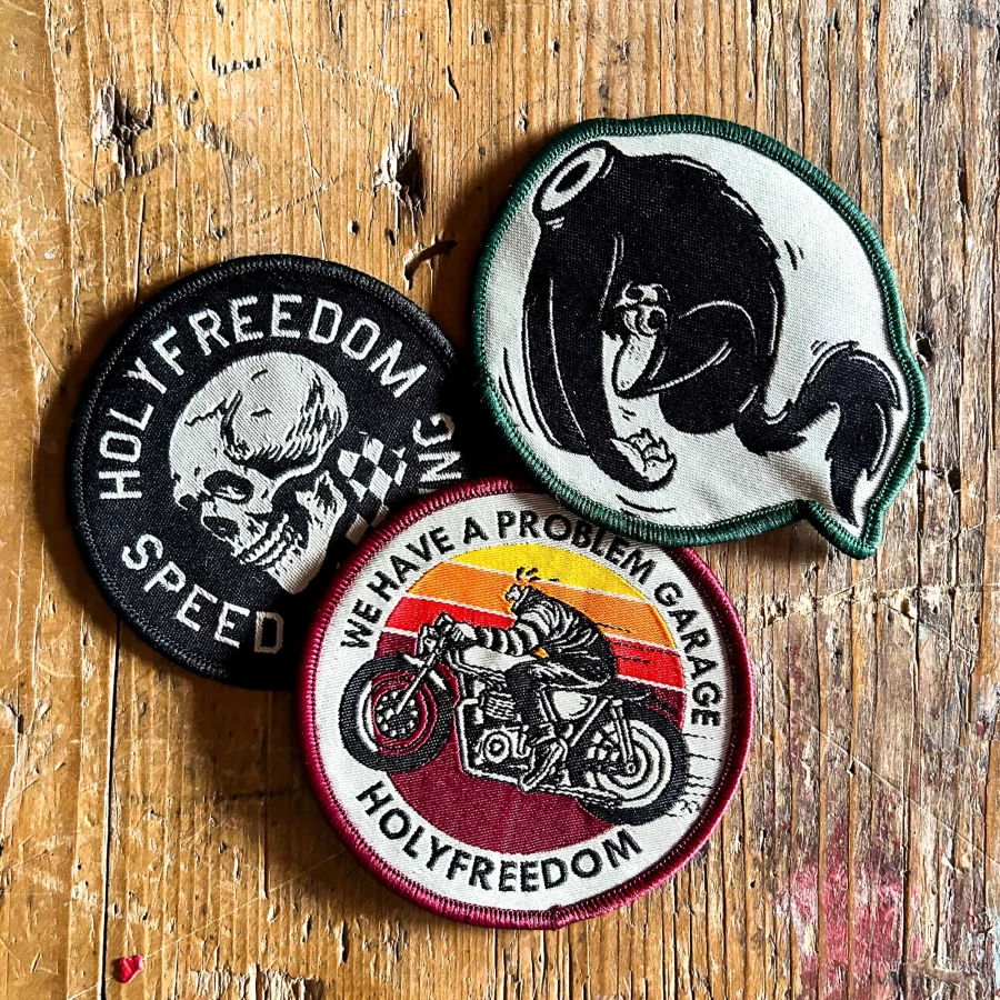 Front view of the Holyfreedom Free Rider Box with three original motorcycle patches.