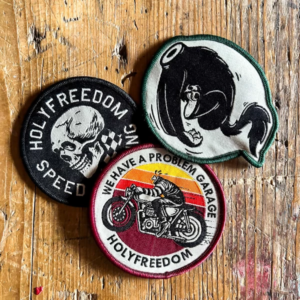 Front view of the Holyfreedom Free Rider Box with three original motorcycle patches.