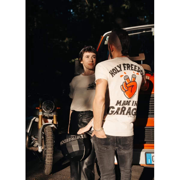 Fit and lifestyle shot of a vintage motorcycle T-shirt styled with denim and boots.