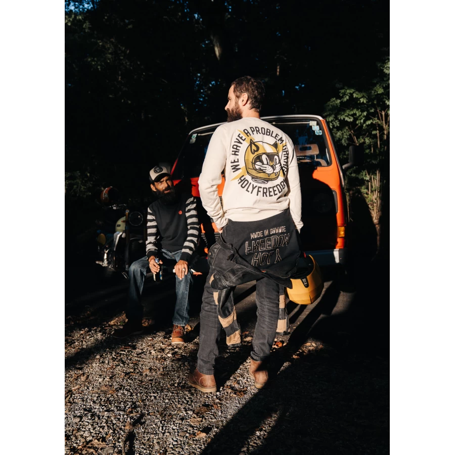 Biker lifestyle shot of the Holyfreedom crewneck sweatshirt, casual and retro.