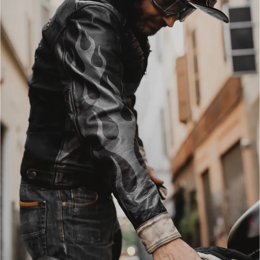 Close detail of the leather and stitching on the vintage riding jacket.