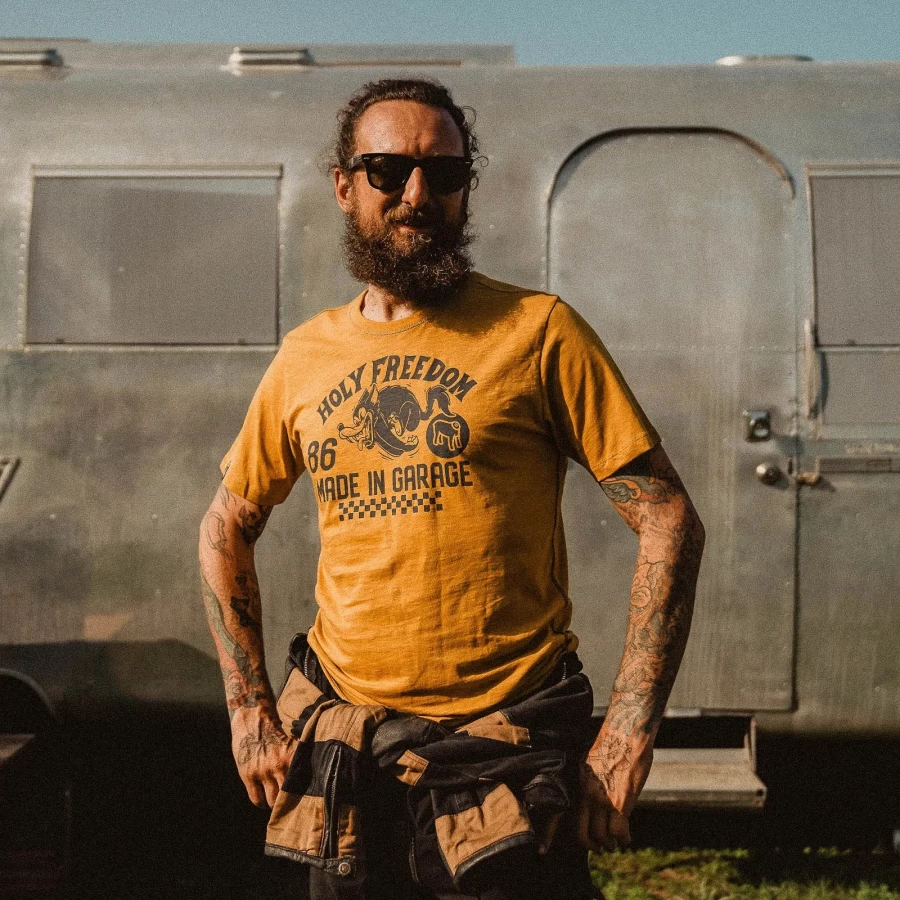 Fit and lifestyle shot of a cafe racer T-shirt paired with jeans and leather layers.