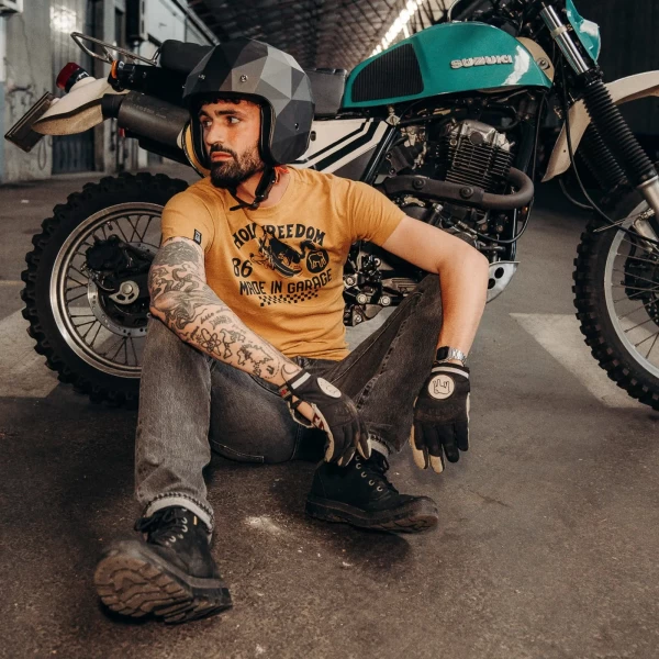 Fit and lifestyle shot of a cafe racer T-shirt paired with jeans and leather layers.