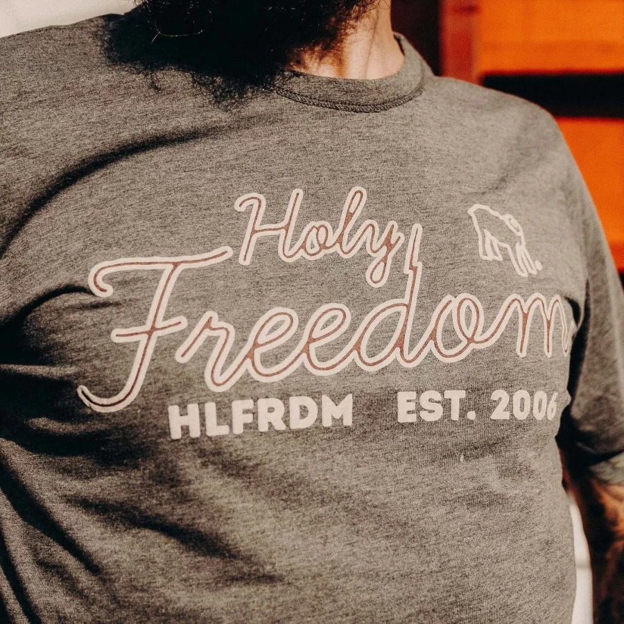 Fabric detail shows the soft mélange texture and minimal finish of this custom tee.