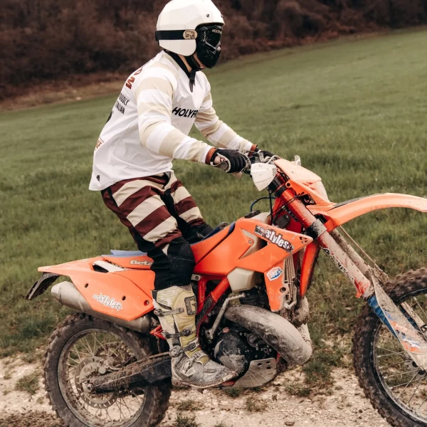 Mud Bordeaux trousers styled off-road with custom jacket and moto boots.