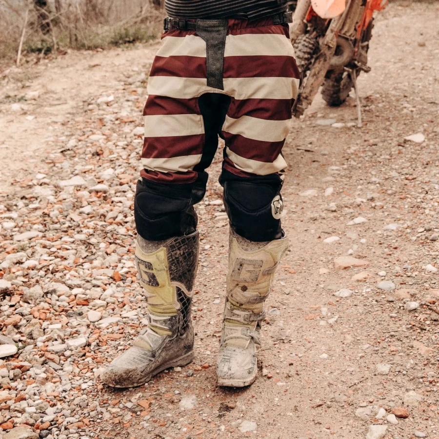 Mud Bordeaux trousers styled off-road with custom jacket and moto boots.