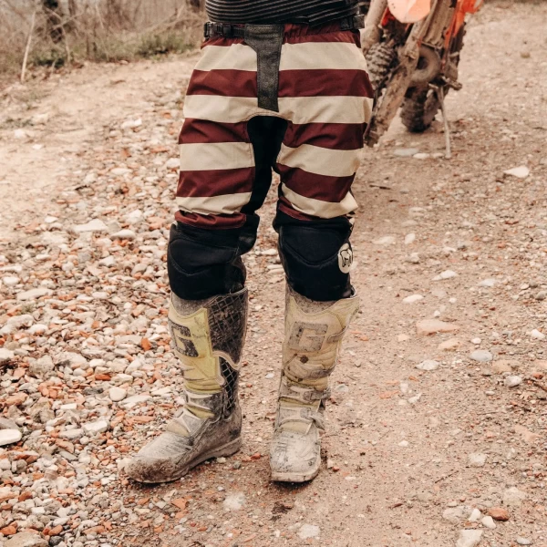 Mud Bordeaux trousers styled off-road with custom jacket and moto boots.