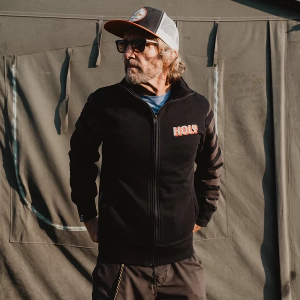 Biker lifestyle shot of the full zip sweatshirt, ideal for layering and casual wear.