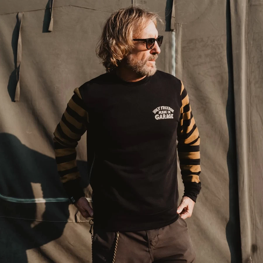 Biker lifestyle image of the crewneck, combining retro style with everyday comfort.