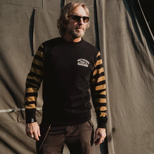 Biker lifestyle image of the crewneck, combining retro style with everyday comfort.