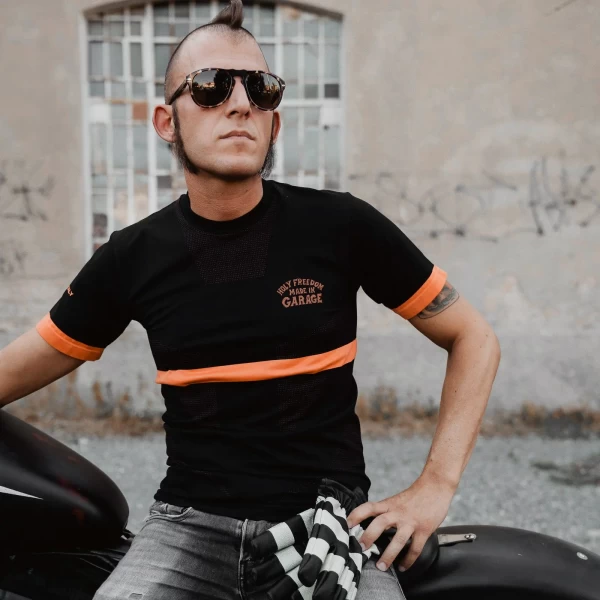 Maglia tecnica moto Striscia indossata sotto la giacca per una guida estiva confortevole.