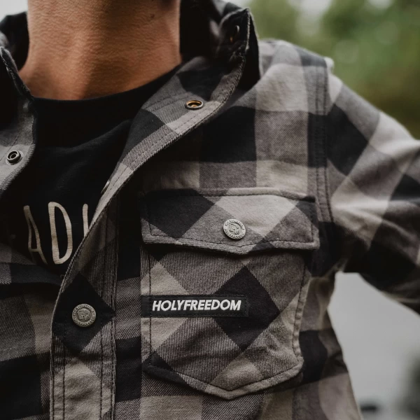 Detail of the Jessie James grey plaid fabric and buttons on the Holyfreedom shirt.