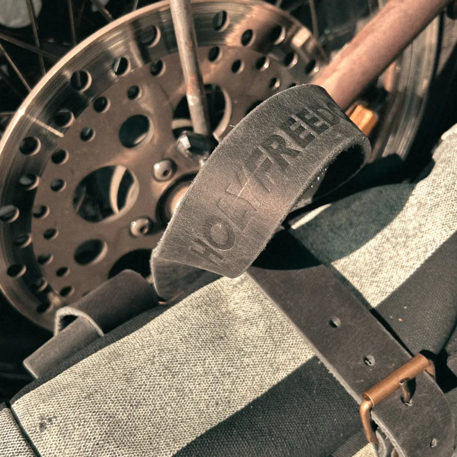 Detail of the roll-top closure and quick motorcycle mounting system on the backpack