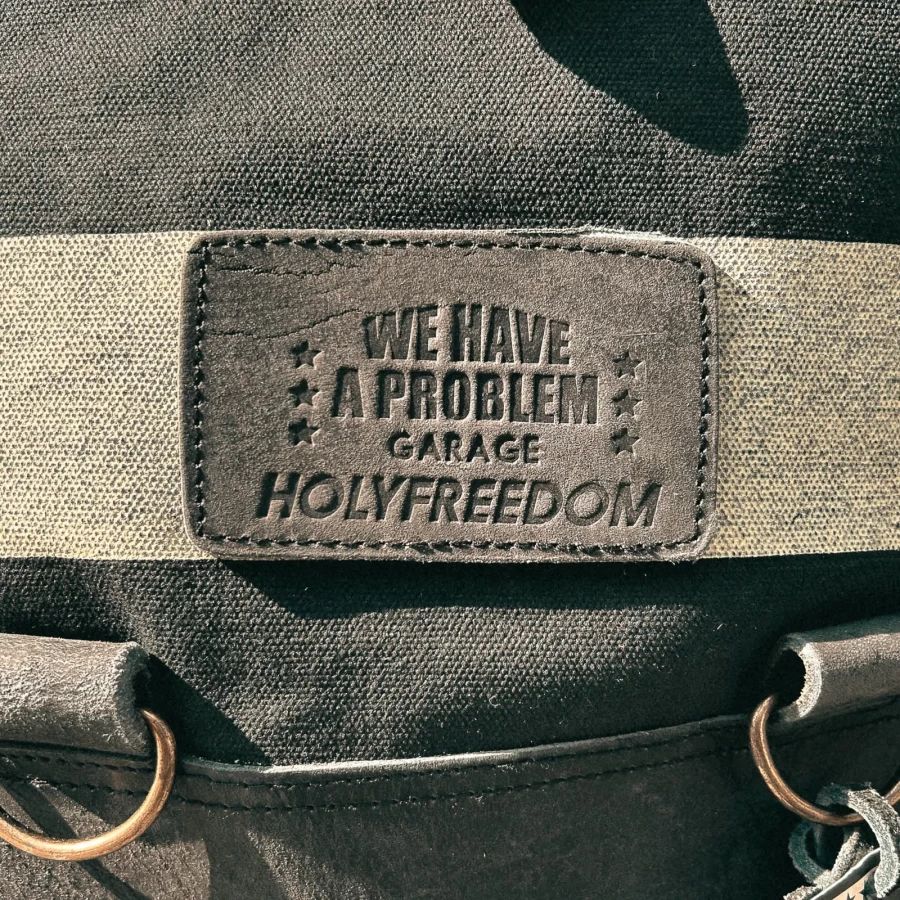 Detail of the roll-top closure and quick motorcycle mounting system on the backpack