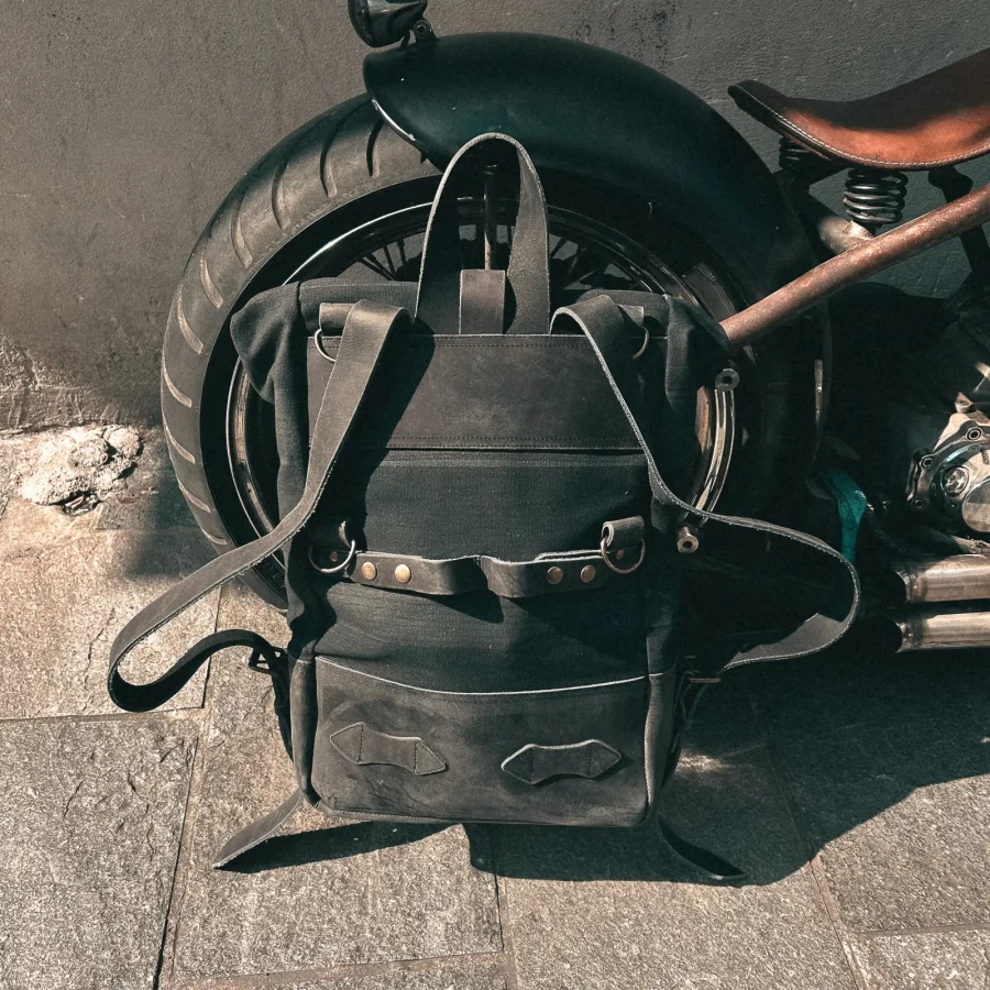 Detail of the black backpack roll-top closure and strap or plate mounting system