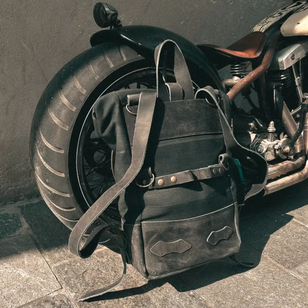 Detail of the black backpack roll-top closure and strap or plate mounting system