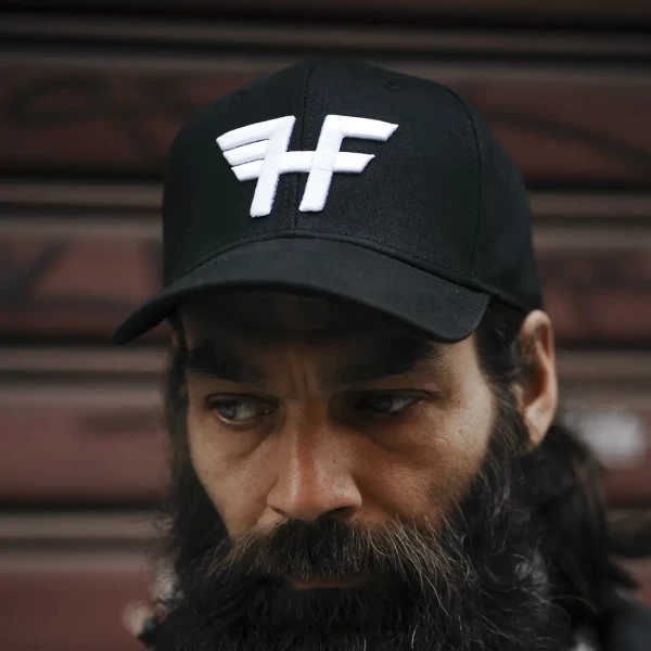 Holyfreedom trucker cap worn in a relaxed biker outfit, breathable and easy for warm days.