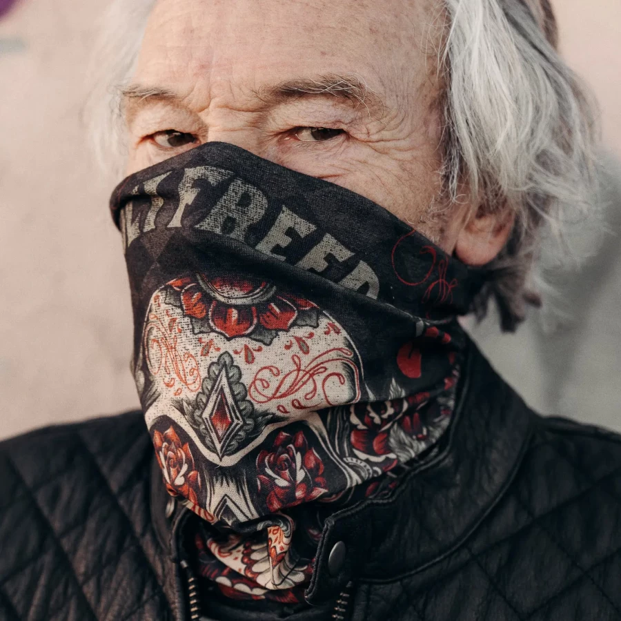 Tube scarf worn as a neck warmer, a winter motorcycle accessory for cafe racer riders.