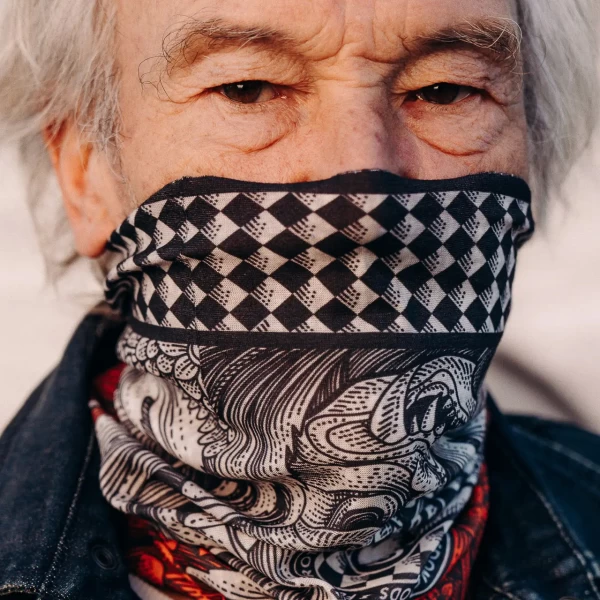 Lifestyle shot of a tube scarf worn on a custom bike ride with cafe racer attitude.