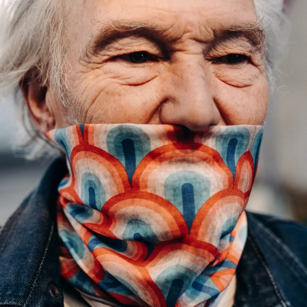Tube scarf worn under a helmet for cafe racer style and everyday comfort