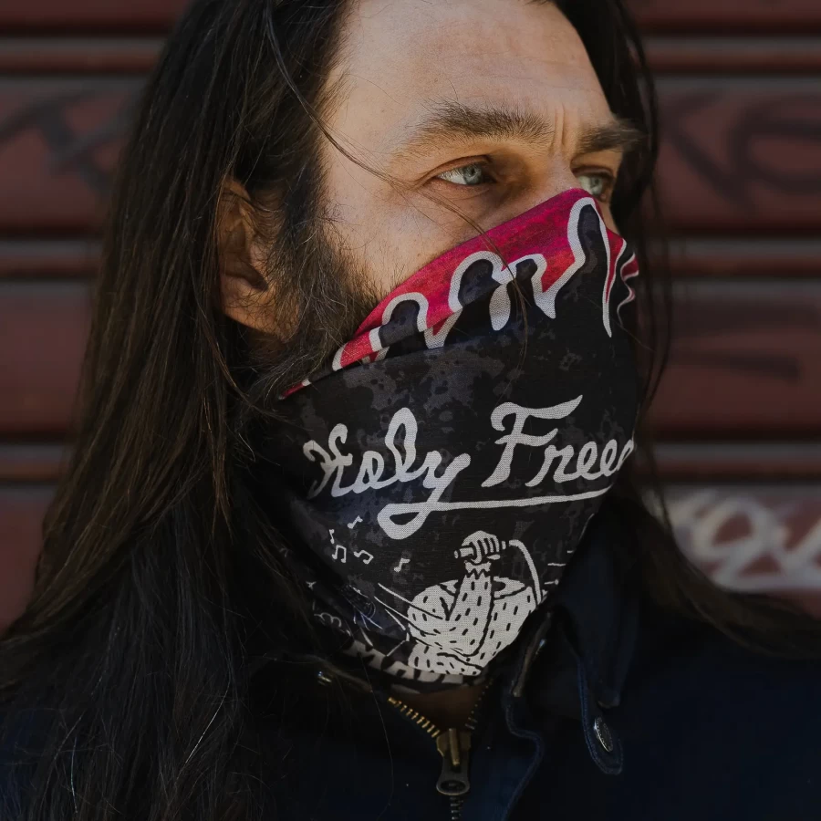 Lifestyle fit of a motorcycle tube scarf for cafe racer rides and city use.