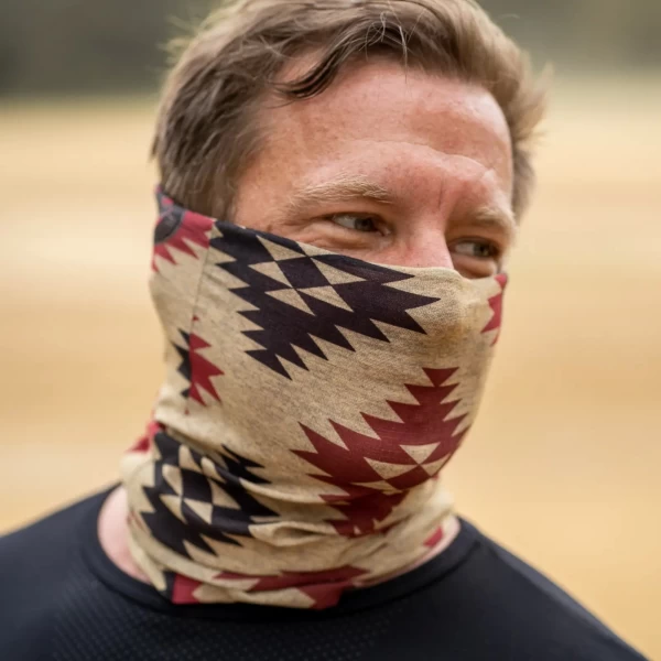 Fit and lifestyle shot of the Cheyenne tube scarf worn under helmet in city riding.