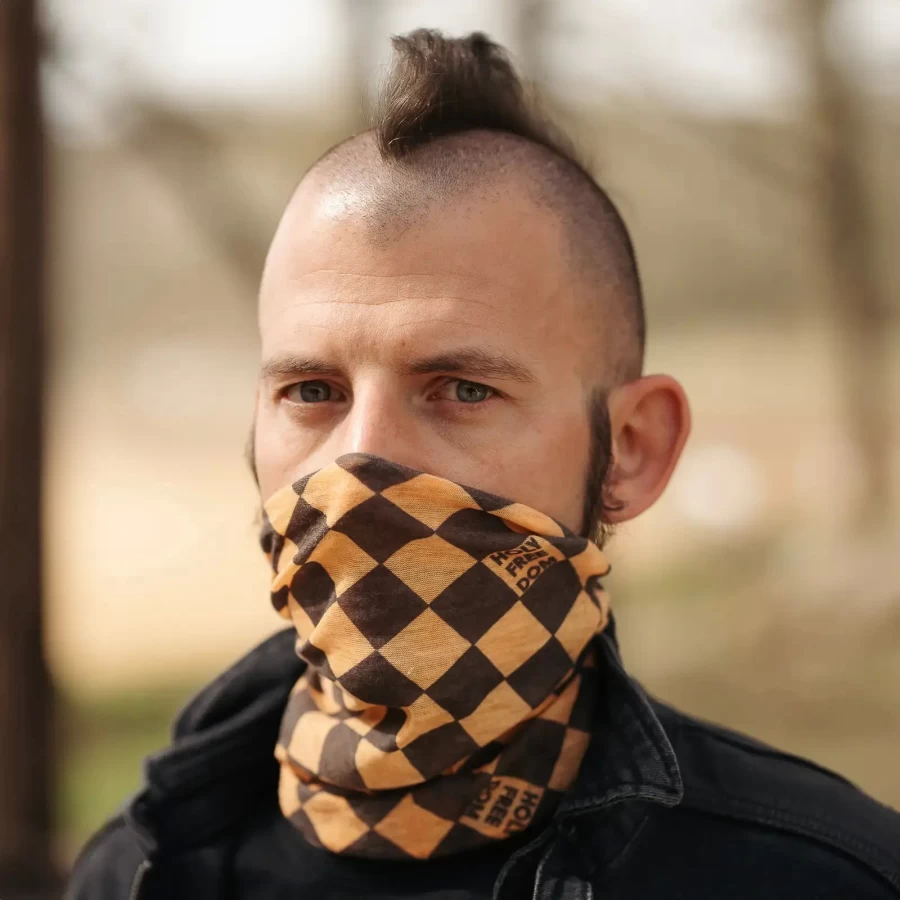 Yellow merino tube scarf worn under a helmet for a standout cafe racer winter look.