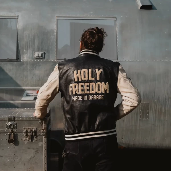 Black varsity jacket worn by a rider for motorcycle use and everyday street wear