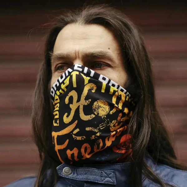 Lifestyle fit of the Flower Power motorcycle tube scarf in a creative custom rider outfit.