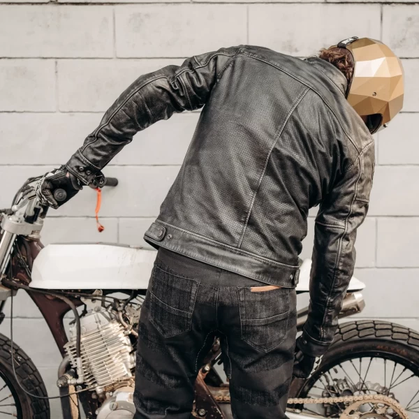 Fit on a custom bike rider wearing a summer leather motorcycle jacket with vintage attitude.