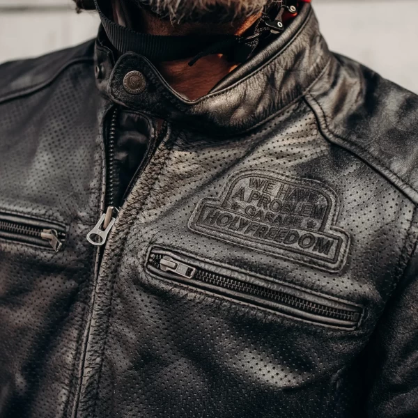 Detail of the black leather finish and clean stitching on this Holyfreedom riding jacket.
