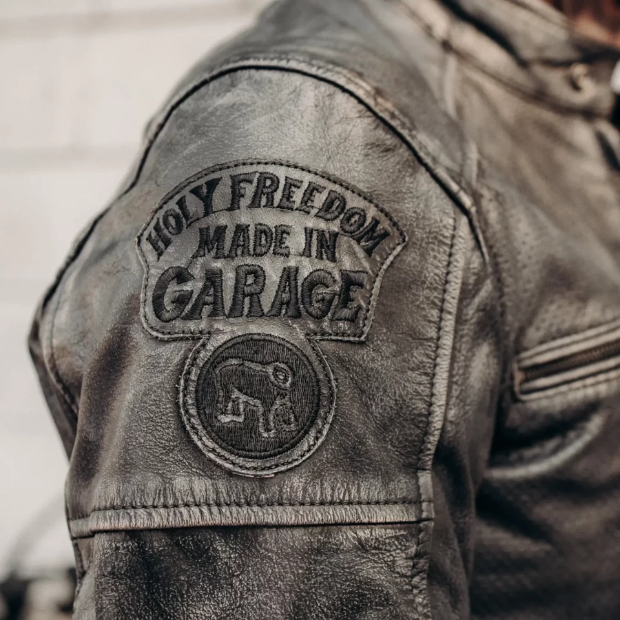 Detail of the black leather finish and clean stitching on this Holyfreedom riding jacket.