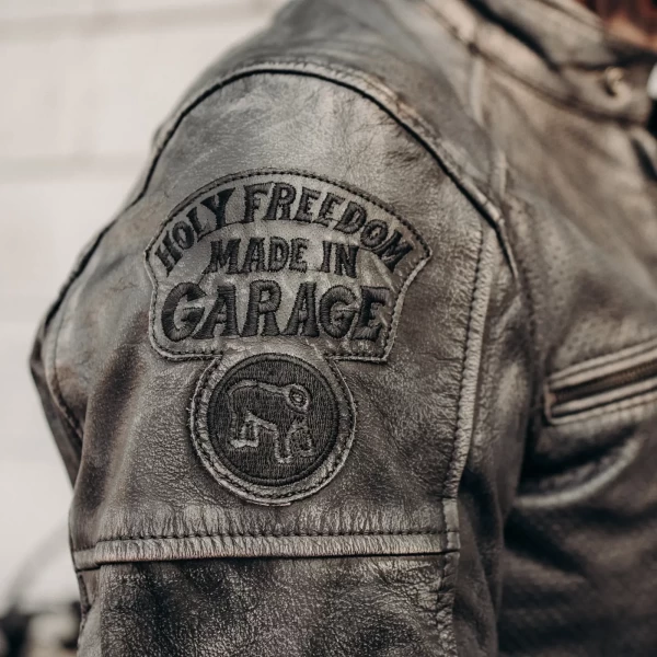 Detail of the black leather finish and clean stitching on this Holyfreedom riding jacket.